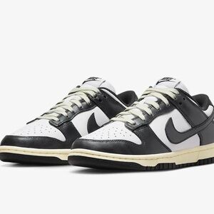 Nike low dunk rpm black and white with cream detail.